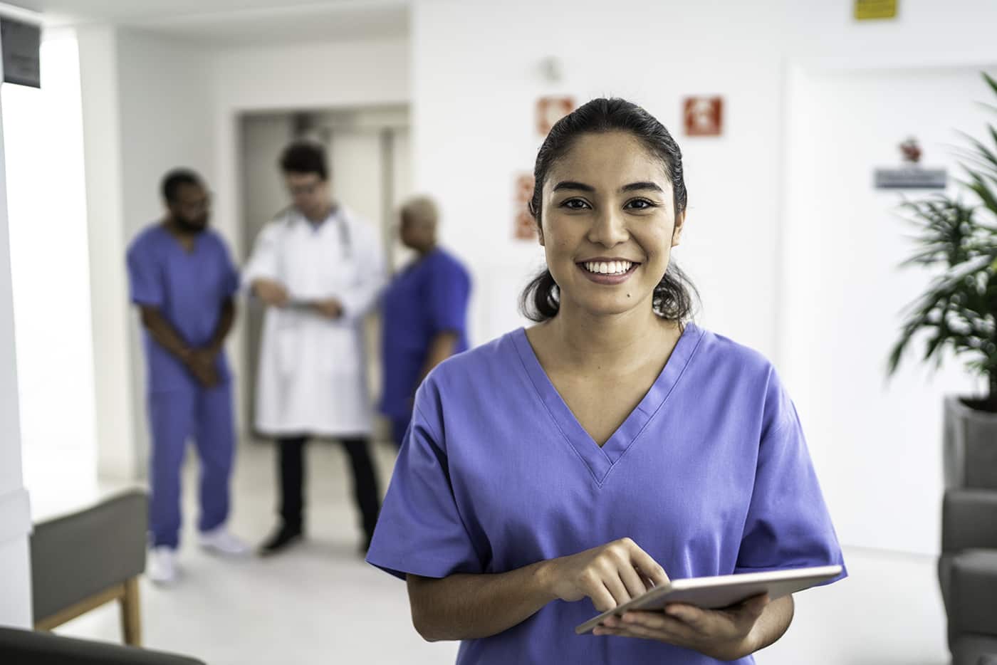 Medical professional holding notebook and smiling